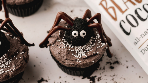 A halloween recipe of a spooky spider cupcake made with black cocoa podwer